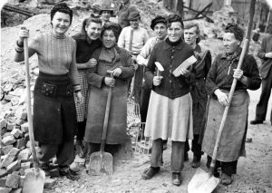 Seven of the many thousand so called rubble women (Truemmerfrauen) pose holding their tools for the camera in the totally bombed out Berlin, Germany, December 22, 1948. (AP Photo)